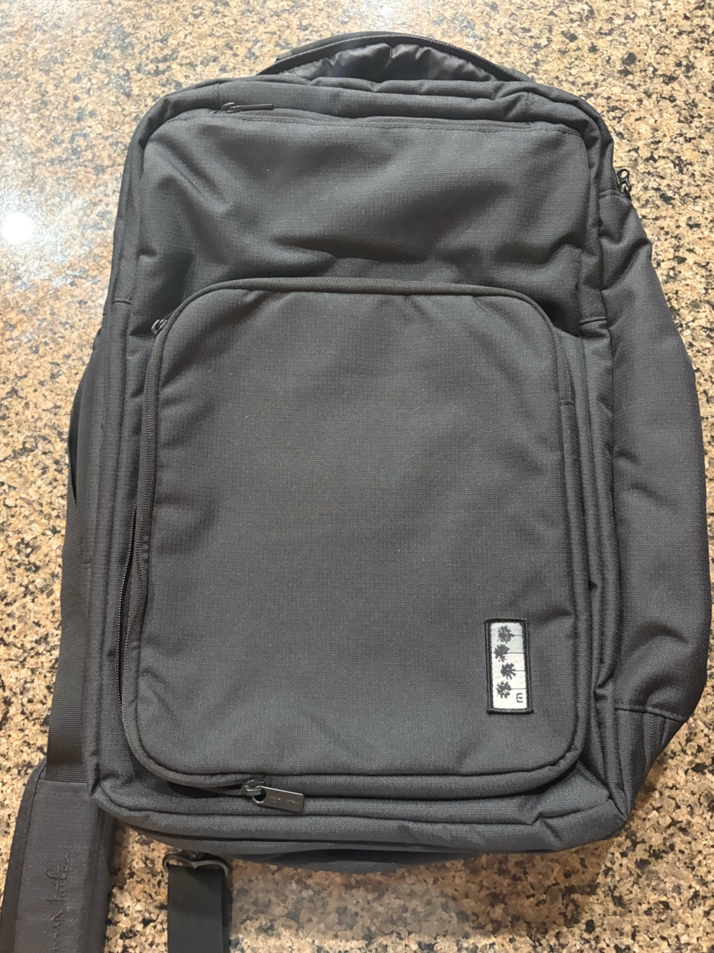 TravisMathew 1st class Lateral convertible Laptop backpack. palm tree logo